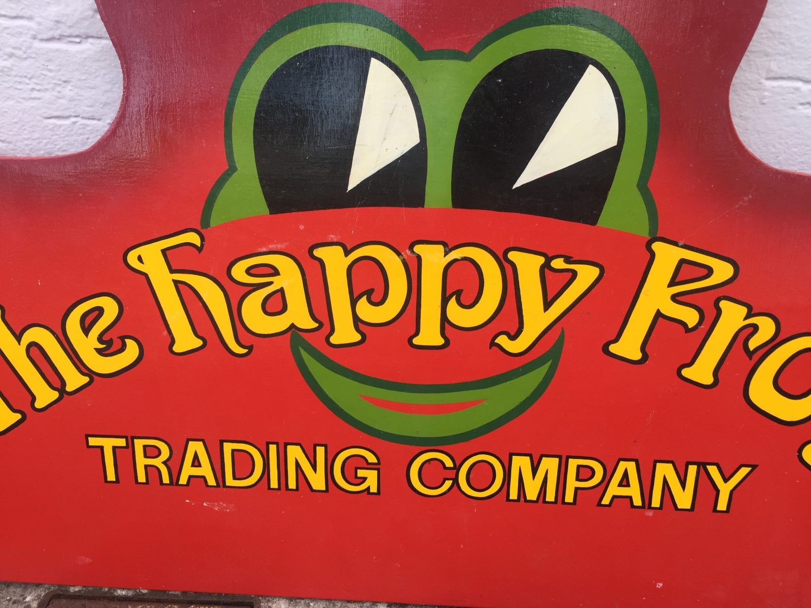 Vintage wooden hand drawn advertising sign The Happy Frog